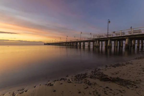 Beautiful sunrise over a wooden pier in Gdynia, Poland — Stock Photo, Image