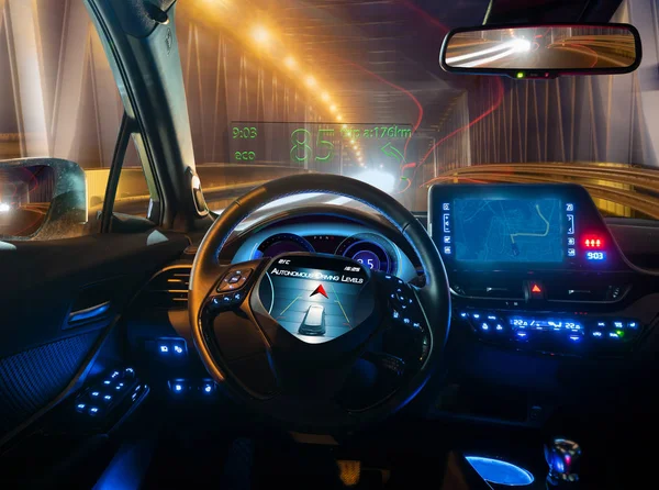 vision of an autonomous car driving at night in a lighted tunnel