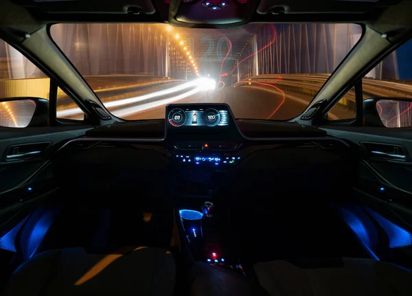 vision of an autonomous car driving at night in a lighted tunnel