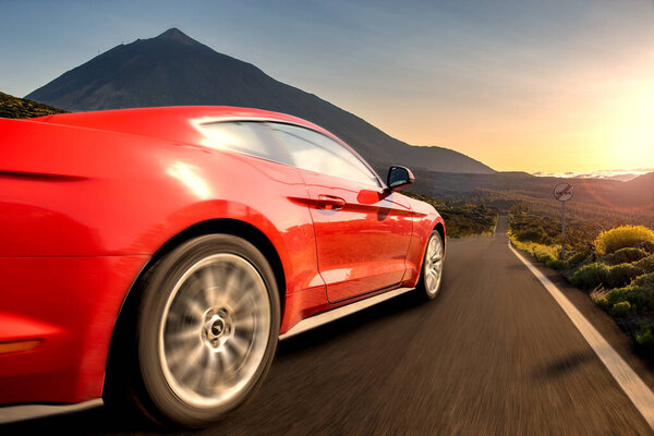 Red sports car running at high speed on the way .Ford Mustang, ro
