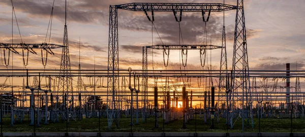 Transformer station and power transmission lines in the setting sun