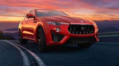 Maserati Levante GranSport while driving on the road at sunset clipart