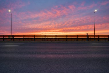 Gün doğumunda şehrin içinden geçen ekspres yol, görüntülemek için mükemmel bir arka levha. arabalar