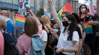 KATOWICE / Polonya - 10 Ağustos 2020: LGBT eşitlik yürüyüşü. Gökkuşağı kıyafeti giyen gençler LGBTQ + hakları için mücadele ediyorlar. Koronavirüs salgını sırasında gösteri. Gökkuşağı bayrakları, bayraklar.