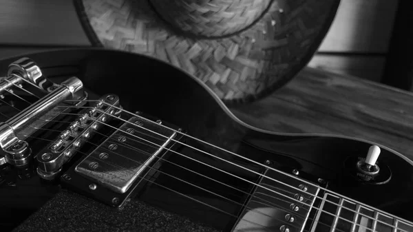 Electric guitar on the wooden boards . Black and white