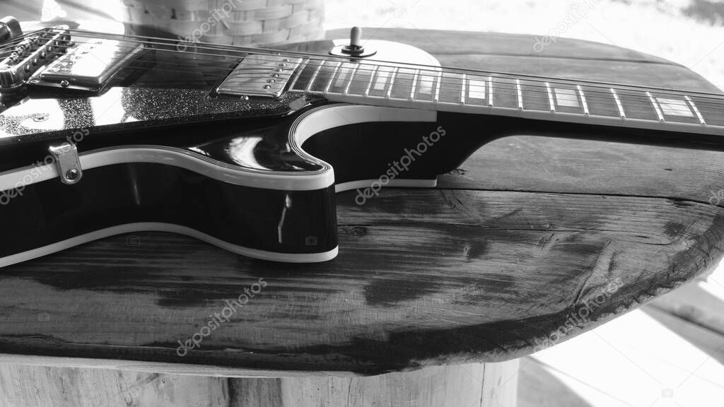     Electric guitar on   the wooden boards with copy space . . Black and white                         