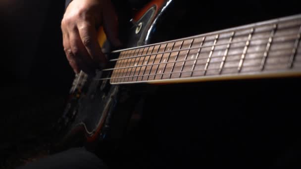 Musician Plays Bass Guitar Dark Background Closeup — Stock Video
