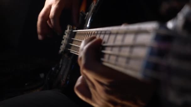 Musician Plays Bass Guitar Dark Background Closeup — Stock Video