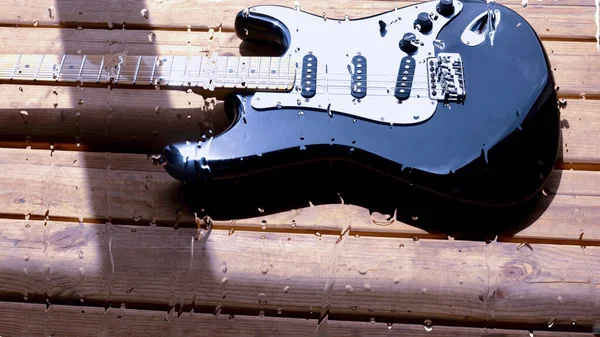 Chitarra Elettrica Sulla Tavola Legno Dietro Vetro Con Gocce Acqua — Foto Stock