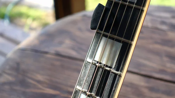 electric guitar on the wooden boards . Closeup , copy space