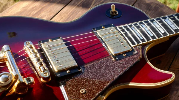 electric guitar on the wooden boards . Closeup , copy space