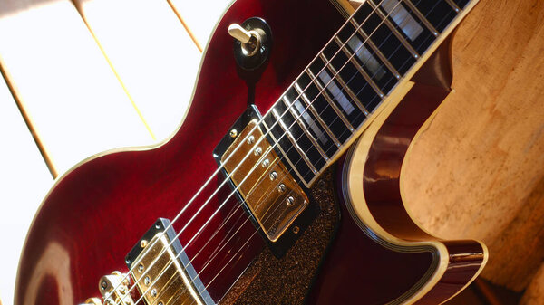 Electric guitar on the wooden boards . Closeup , copy space