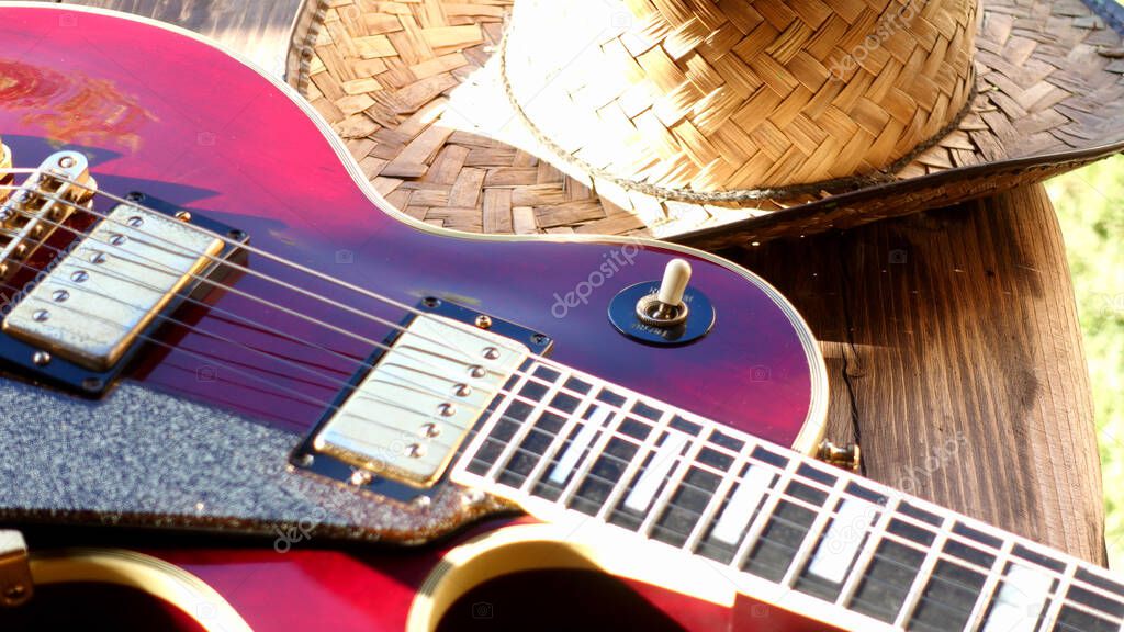 electric guitar on the wooden boards . Closeup , copy space