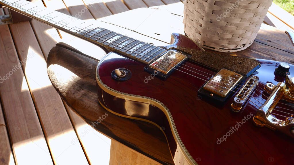 electric guitar on the wooden boards . Closeup , copy space