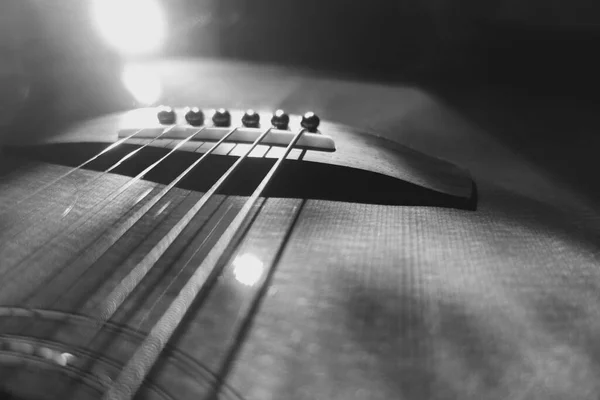 acoustic guitar closeup . black and white