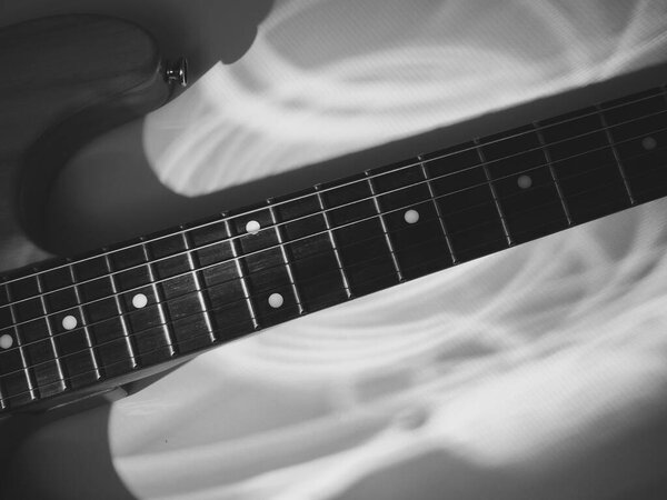Electric. guitar closeup in the stage light . black and white