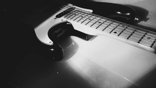 Electric guitar closeup in the stage light . black and white