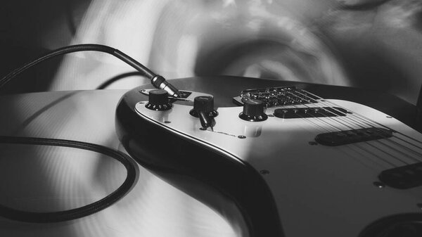Electric guitar closeup in the stage light . black and white