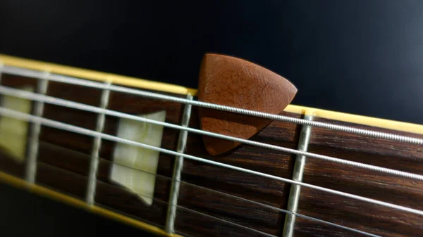 electric guitar neck and headstock closeup . color background