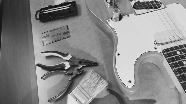 Repair guitar closeup. black and white