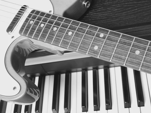 electric guitar and piano keyboards . closeup . musical instruments