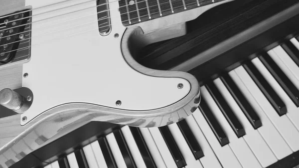 electric guitar and piano keyboards . closeup . musical instruments