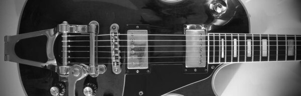 Electric guitar closeup . copy space . black and white