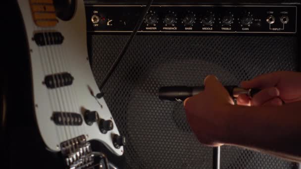 Musician Adjusts Guitar Amp — Stock Video