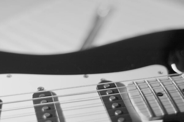 Electric guitar and notes closeup . black and white