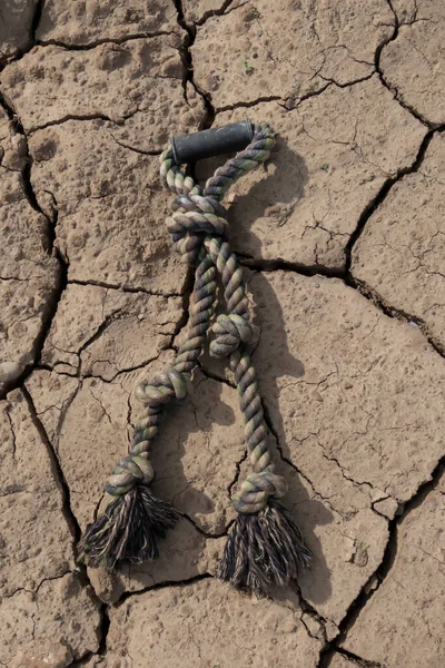 old rope on the broken dry ground