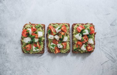 Bruschetta toast with guacamole and tomatoes. clipart