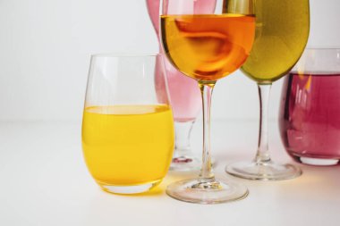 Beyaz arka planda çok renkli içkiler olan bardaklar. Yüksek kalite fotoğraf