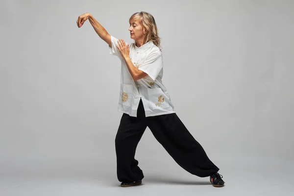 Mujer Rubia Madura Practicando Chi Kung Tai Chi Sobre Fondo — Foto de Stock