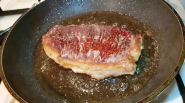 Yağlı sulu Güney Amerika prim sığır eti biftek bir tavada yağda kızartılır