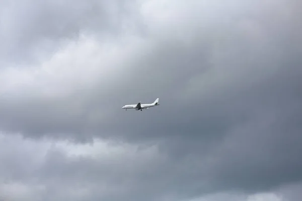 Aviones de pasajeros en el cielo gris nublado — Foto de Stock