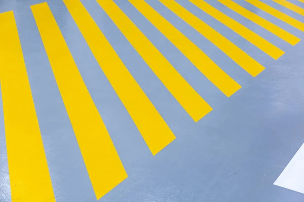 Yellow striped walkway for staff in the production workshop of an industrial plant