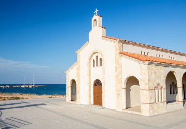 Mavi denizin arka planında yeni ve güzel bir kilise.