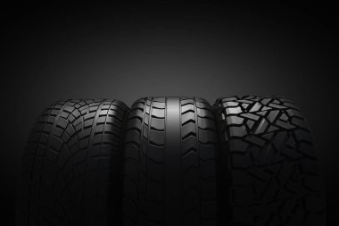 Siyah arka planda 3D araba lastikleri.