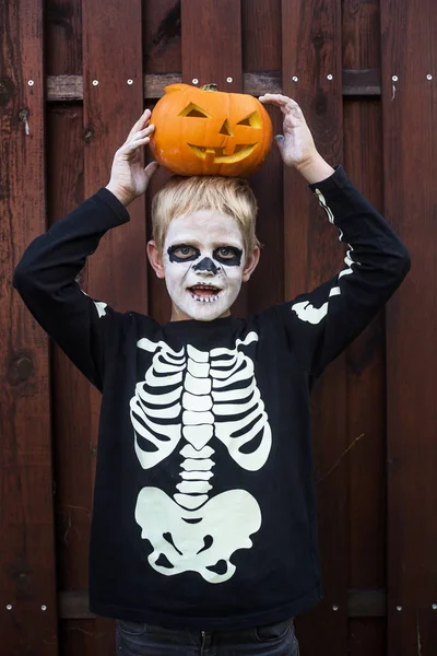 Happy Young Blond Hair Boy Skeleton Costume Holding Jack Lantern Stock Image