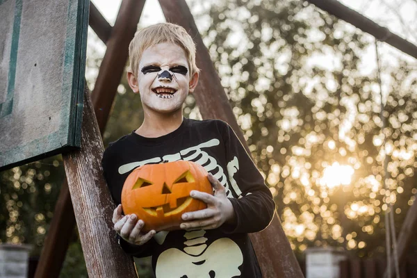 Happy Young Blond Hair Boy Skeleton Costume Holding Jack Lantern Stock Photo