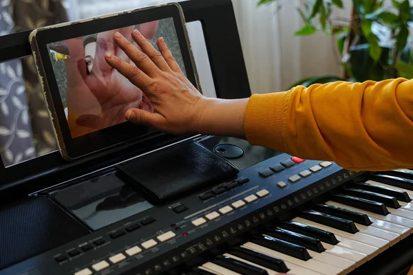 Virtual handshake of musicians before the rehearsal on the Internet. Female musicians rehearsing online during self-isolation due to pandemic