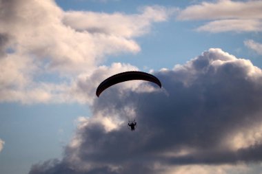 Paraglider fırtına gökyüzünde uçar. Planör havada hafif bir uçak planları.