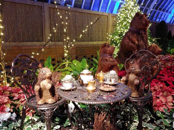 Fairy tale characters are sitting at the table, figures from the tree of hares and bears