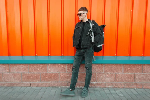 Handsome Young Man Black Fashion Clothes Stylish Backpack Orange Wall — Stock Photo, Image