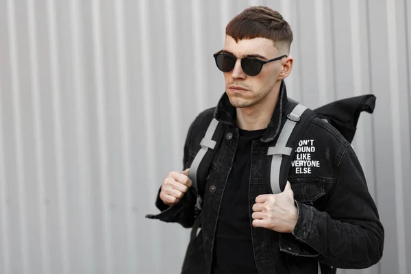 Handsome Young Man Black Sunglasses Black Denim Clothing Backpack Gray — Stock Photo, Image