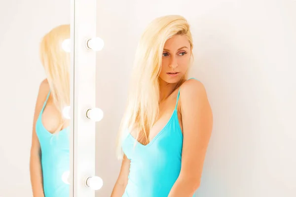 Young beautiful model woman in blue underwear near white mirror — Stock Photo, Image