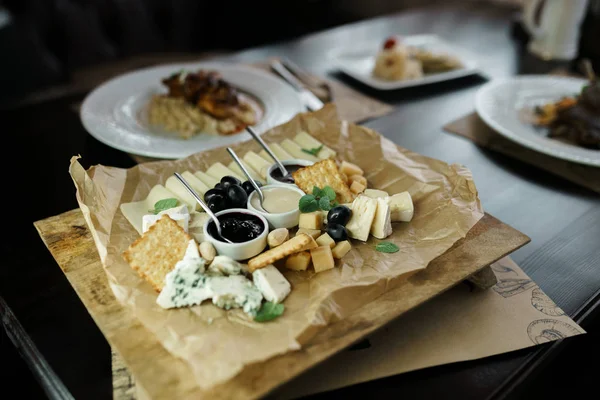 Platter from: Parmesan cheese, Gouda cheese, feta, blue cheese with sweet honey and lingonberry jam, decorated with fragrant basil leaves and olives. Great snack. Cheese platter
