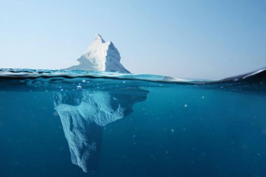 Iceberg in the ocean with a view under water. Crystal clear water. Hidden Danger And Global Warming Concept 