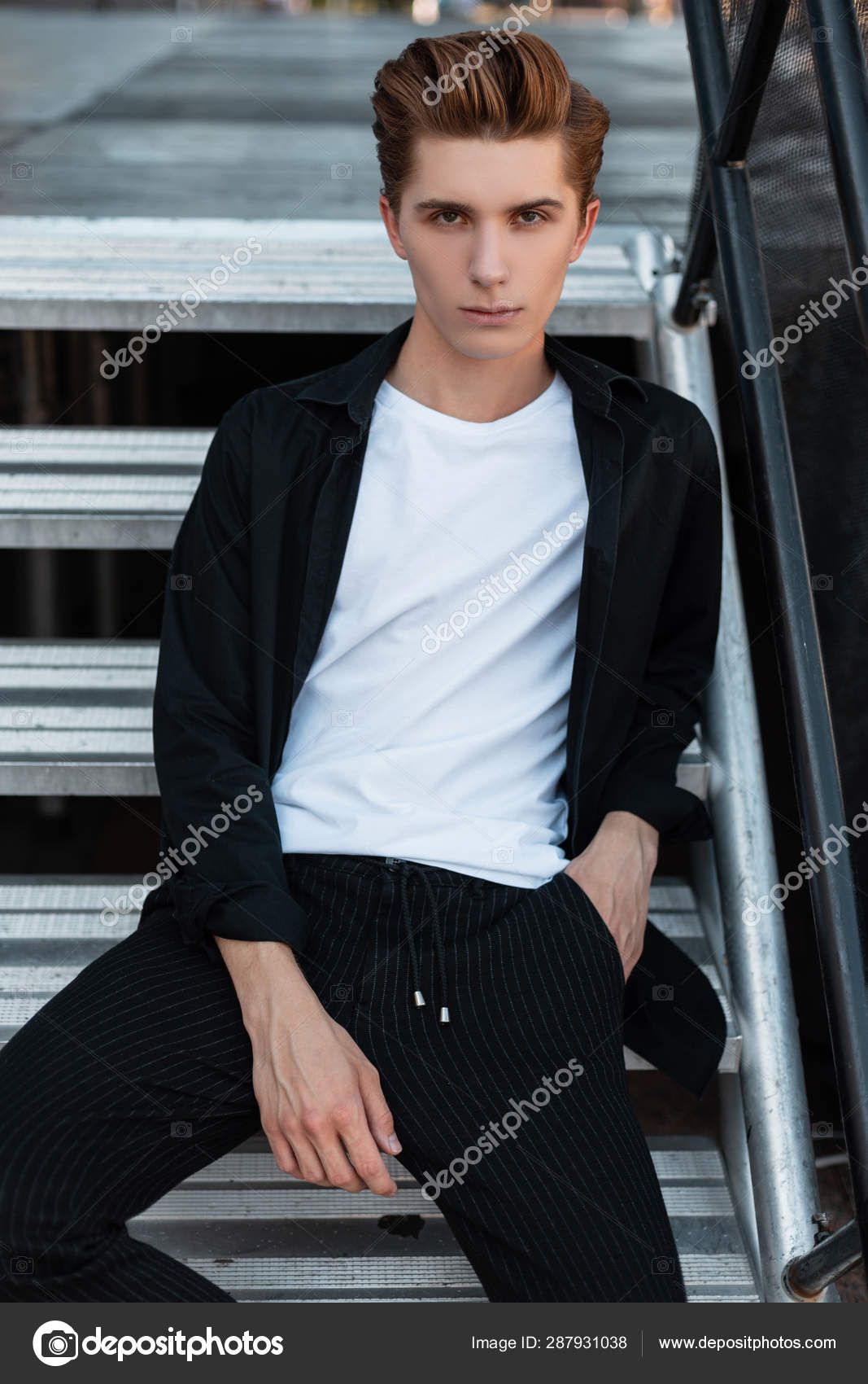 Modern Attractive Young Man With A Stylish Hairstyle In A T Shirt