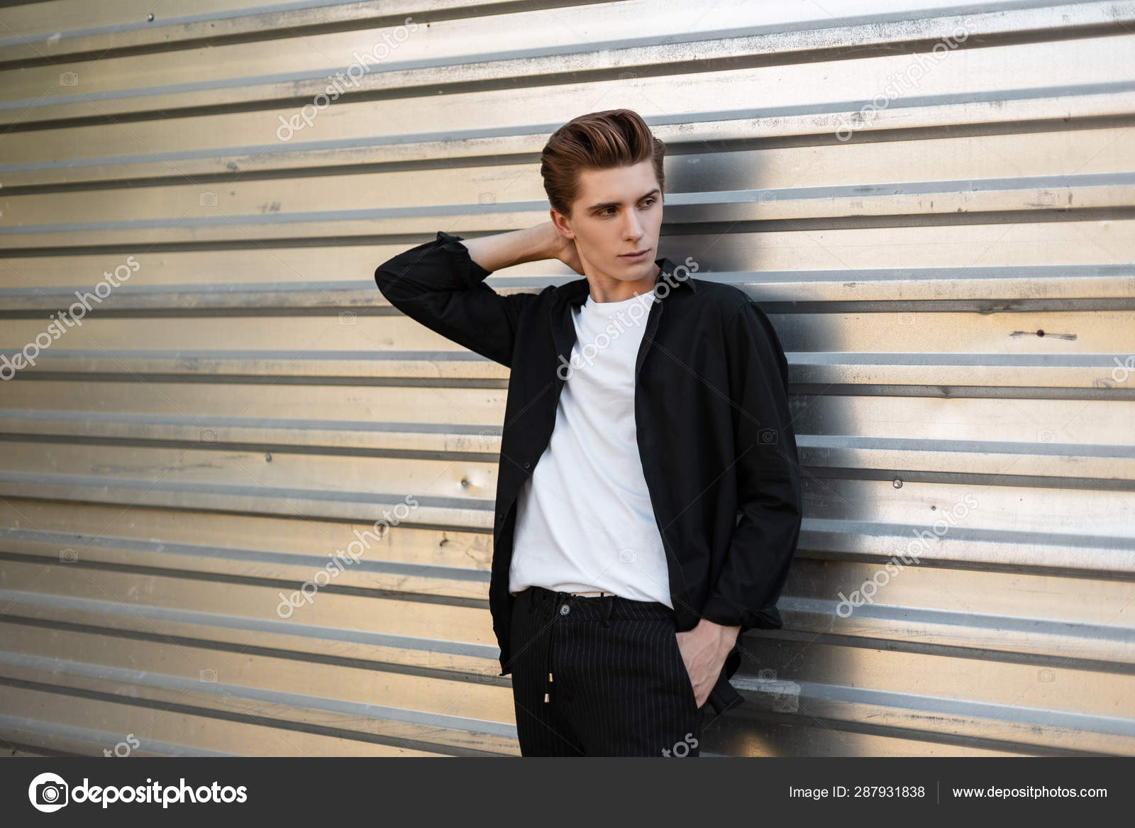 Portrait of handsome successful male entrepreneur in stylish shirt smiling  self-assured standing in confident pose with hands in pockets being  satisfied with rich life after business got well financed Stock Photo |